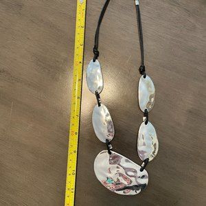 Hammered metal statement necklace on cloth cord